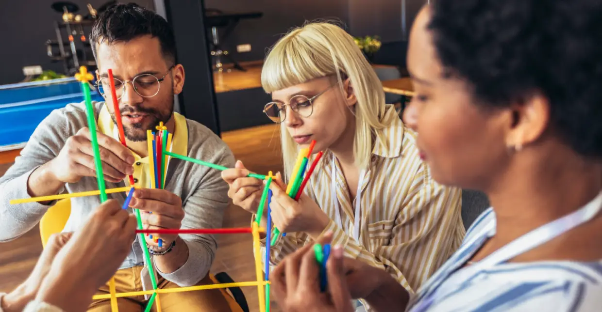 A group creating colorful friendship bracelets together.